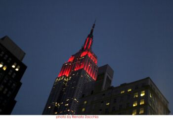 The Empire State building is illuminated Ferrari red