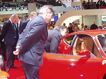 Fiat Group CEO Sergio Marchionne inspects the Ferrari F430 on the occasion of its 'World Premiere' at the 2004 Paris Mondial de l'Automobile, under the watchful eye of Ferrari's head of design, Frank Stephenson