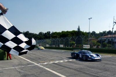 Andrea Bertolini crosses the finish line at Imola in the Maserati MC12