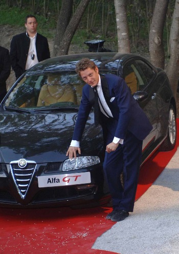 An Alfa Romeo GT, donated by the Italian car maker to raise money for the 'Cinema against Aids' charity, was auctioned at the "Moulins de Mougins" by Sharon Stone and Lapo Elkann