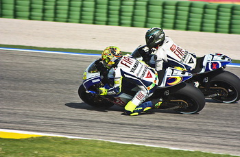 Valentino Rossi and Jorge Lorenzo finished second and third in the season-ending Grand Prix of Valencia on Sunday afternoon, the ninth time the pair have shared the podium this season. It ensured that Yamaha won the Triple Crown for the second year running after Rossi took the Riders' title, Fiat Yamaha the Teams' and Yamaha the Constructors'.