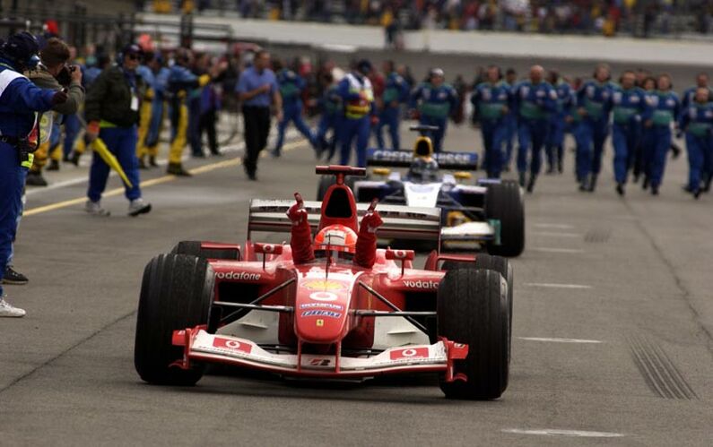 Michael Schumacher celebrates winning the United States Grand Prix