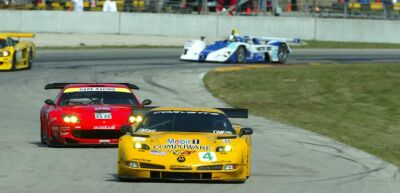 the 88 Ferrari 550 Maranello chases a rival Chevrolet Corvette at Road America