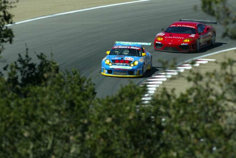 The Calpoint Risi Competizione Ferrari 360 Modena chases a Racer's Group Porsche at Laguna Seca