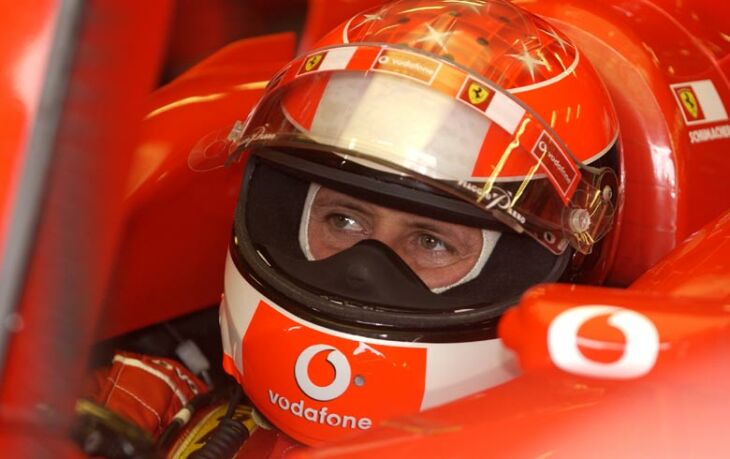 Michael Schumacher watches the monitor during qualifying